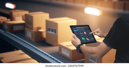 Smart Warehouse,Inventory management system concept.Manager using digital tablet,showing warehouse software management dashboard on blurred warehouse as background - Powered by Shutterstock