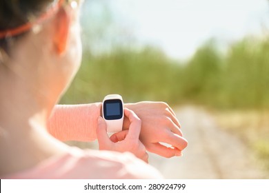 Smart Watch Fitness Tracker. Athlete Wearing Heart Rate Monitor Wristwatch Using Screen. Runner Looking At Sports Smartwatch Getting Ready Going Running Using Wearable Tech.