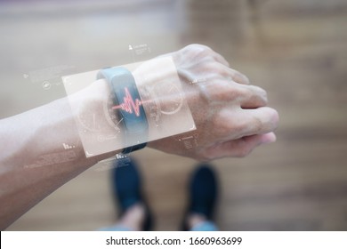 Smart watch and smart gadget technology. Hand using futuristic smart watch monitoring health data - Powered by Shutterstock