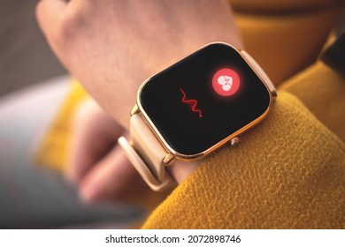 Smart watch with heart rate icon, healthcare concept photo. Woman measuring heart rate with application - Powered by Shutterstock