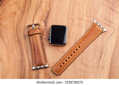 Smart watch, leather strap  on dark wood background - Powered by Shutterstock
