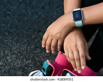 Smart Watch On A Sporting Girl Wrist. Smart Watch Health, Heart Rate And Fat Burn Monitoring. Jogging Goals Preparation. Bright Everyday Sport Concept Mock Up. Lifestyle Concept.