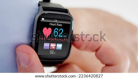 Smart Watch Showing Heartbeat Monitor On Man's Hand