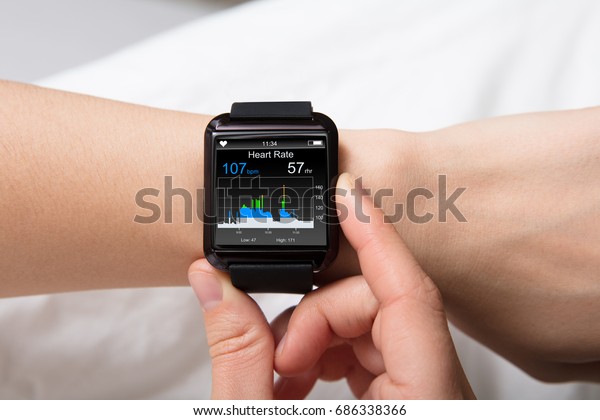 Smart\
Watch Showing Heartbeat Monitor On Woman\'s\
Hand