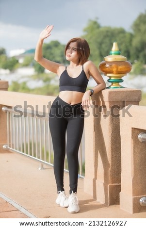 A smart woman model short hair in sport wear for running and exercise on park in evening , she like this for good health and slim body