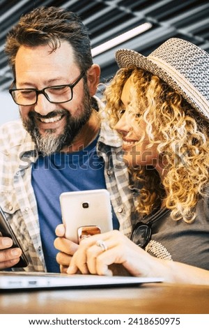 Smart working and digital nomad. alternative eveywhere office concept with couple of caucasian people use phones device and laptop computer during fly travel in airport or bar