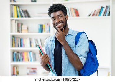 Smart Young African American Male Student With Beard At Library Of University