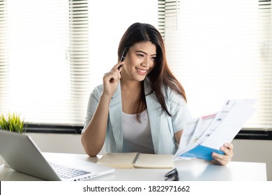 Smart Young Asian Woman Feeling Happy That She Can Solve Credit Card And Financial Problem. The Girl Holding Debt Bills With Smile With Confident Face.