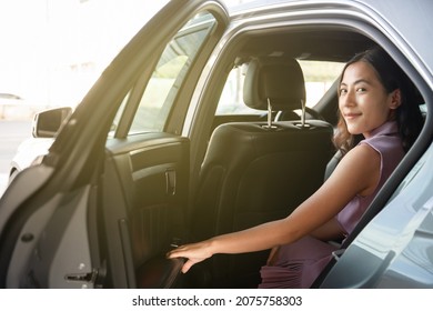 Smart Young And Beautiful Asian Businesswoman Getting In Or Getting Out Of A Car, Business Travel In Modern - Urban Lifestyle. Business Woman Travel In The City By Private Taxi.