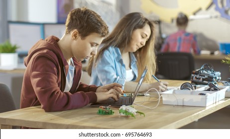 Smart Young Boy Works on a Laptop For His New Project in His Computer Science Class.