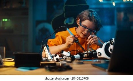 Smart Young Teenage Schoolboy is Studying Electronics and Soldering Wires and Circuit Boards in His Science Hobby Robotics Project. Kid is Working on a Robot in His Room. Education Concept.