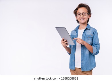 Smart young white boy using tablet in casual outfit isolated over white background - Powered by Shutterstock