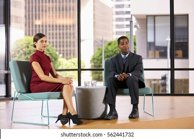 Smartly Dressed Man And Woman On Set For A TV Interview