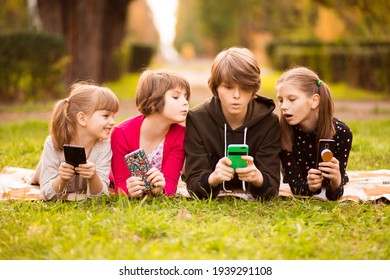 Smartphone addiction group of little children watching film movie cartoon together on digital tablet. Kids playing with phone together