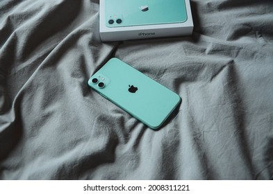 Smartphone Apple IPhone 11 Mint Green With Box Picture Taken On A Bed Inside A Room On The Day Of Purchase. Omsk, Russia 18 June 2021. 