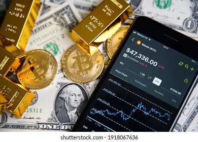 Smartphone Application. CoinGecko Logo On Phone Screen Close Up. On The Table In The Background American Money, Bitcoin And Shiny Gold Bars. Budapest, Hungary - February 10, 2021 