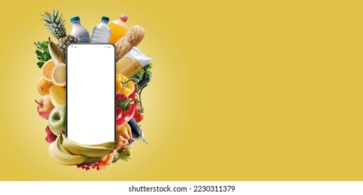 Smartphone with blank screen and fresh groceries: online grocery shopping app - Shutterstock ID 2230311379