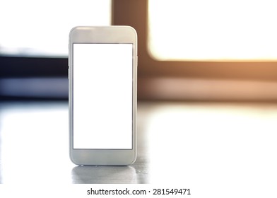 smartphone with blank screen standing on wooden table. - Powered by Shutterstock