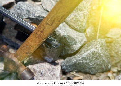 Smartphone Broken Glass With Hammer On Gravel Stones. Selective Focus With Sum Beam.