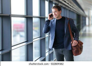 Smartphone Business Man Talking On Mobile Phone In Airport - Travel Lifestyle. Businessman Using Smartphone Calling On Phone Walking In Corporate Building Or On Work Commute In Public Transit Area.