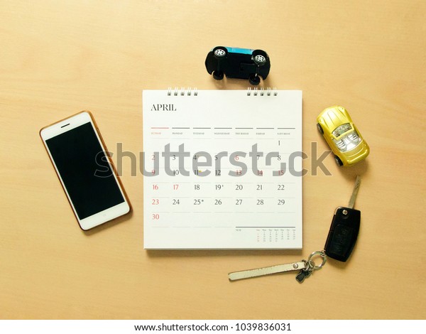 Smartphone, calendar, car key and two model cars\
are demonstrated crashing. Using mobile application to apply car\
insurance or emergency\
calling.