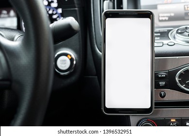 Smartphone in a car use for Navigate or GPS. Driving a car with Smartphone in holder. Mobile phone isolated white screen. Blank empty screen. copy space. Empty space for text. car interior details.