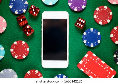 Smartphone and casino chips stacking on a green felt. - Powered by Shutterstock