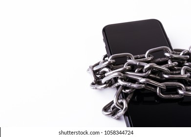 Smartphone in chains isolated on white background. Slave concept