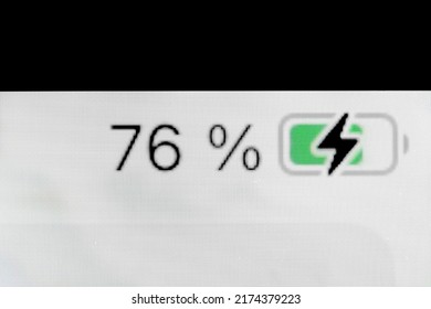 Smartphone Charged Pixel Battery Level Indicator - Charging Process - Seventy-six, 76 Percent: Close Up Macro View Of Gadget Display, Screen. Energy, Technology, Power, Digital And Symbol Concept