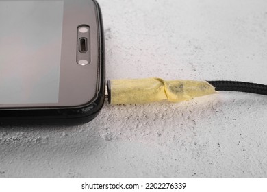 Smartphone Charger Wire Frayed. Close-up.