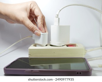 Smartphone charging with cable, one charging cable is broken, isolated on white - Powered by Shutterstock