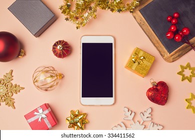 Smartphone with Christmas decorations. Christmas mock up template. View from above - Powered by Shutterstock