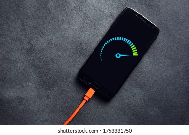 Smartphone Connected To A Usb Charging Cable And Fast Charging On Black Background. Phone Fast And Quick Speed Charge. 