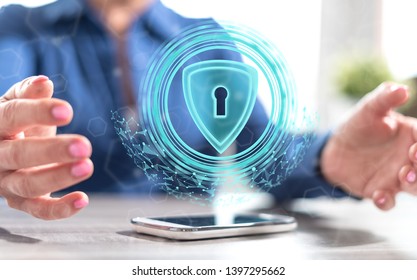 Smartphone with data security concept between hands of a woman in background