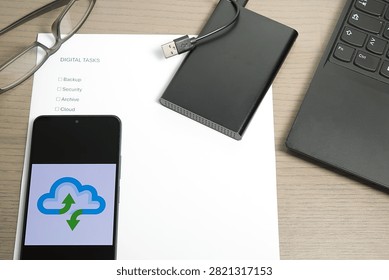 Smartphone displaying a cloud icon resting on a 