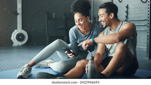 Smartphone, fitness and personal trainer talking to client for exercise goal planning on mobile app, internet search or health software. Young sports people on floor in conversation and using phone - Powered by Shutterstock