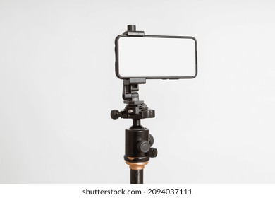 Smartphone Fixed On A Tripod In A Horizontal Position With A Blank Screen On A White Background, Mockup