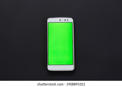 Smartphone With Green Screen On Black Background.