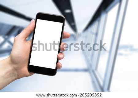 smartphone in hand and blurred background