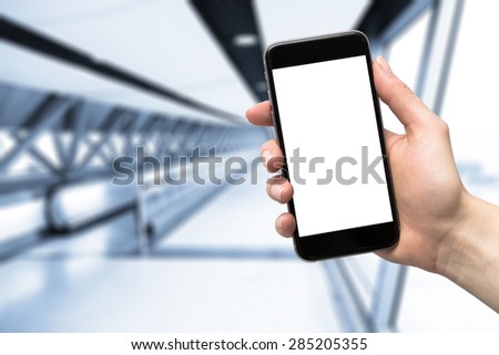 smartphone in hand and blurred background