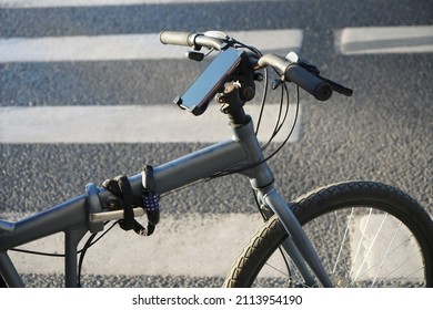 Smartphone Holder For Bike On  Pedestrian Crossing Background. Cell Phone Holder On Bicycle To Use Gps For Guidance In City Center 