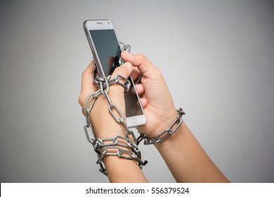 smartphone with lock chain on a white background. Concept of  Social Disease - Shutterstock ID 556379524