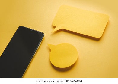 Smartphone and Message bubbles chat papper on yellow background