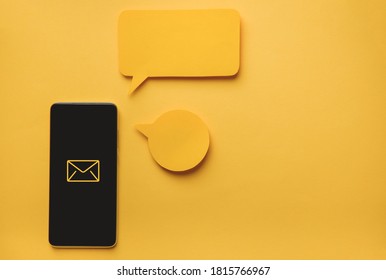 Smartphone and Message bubbles chat papper on yellow background