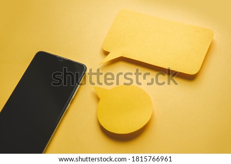 Smartphone and Message bubbles chat papper on yellow background