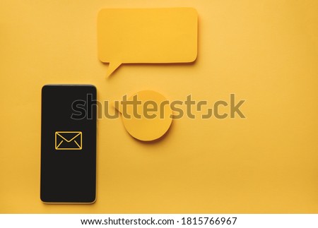 Smartphone and Message bubbles chat papper on yellow background