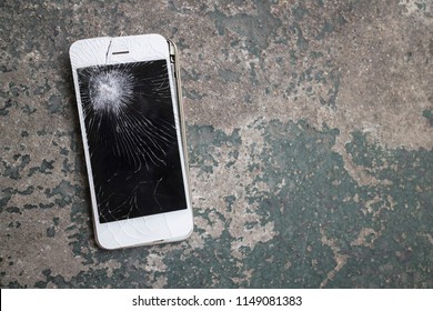 Smartphone mobile fall on the cement floor with touch screen broken.