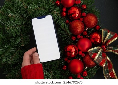 Smartphone mock up template white screen on handmade Christmas wreath. Zero waste eco-friendly Christmas. Sustainable greeting card - Powered by Shutterstock