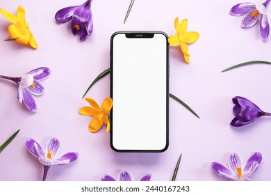 Smartphone mockup with violet and yellow crocuses flowers. Device screen mockup on stylish background for presentation or app design. Top view, copy space for text, product place. - Powered by Shutterstock