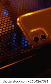 Smartphone at night on a technological table with neon lights.